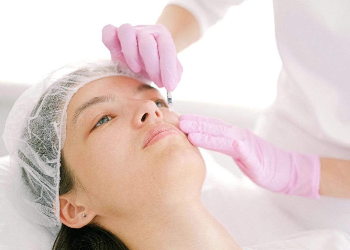 Close-up of woman receiving botox injection at clinic